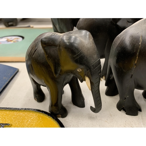 279 - A COLLECTION OF SEVEN WOODEN ASIAN ELEPHANTS