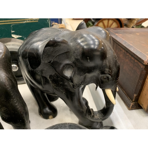 279 - A COLLECTION OF SEVEN WOODEN ASIAN ELEPHANTS