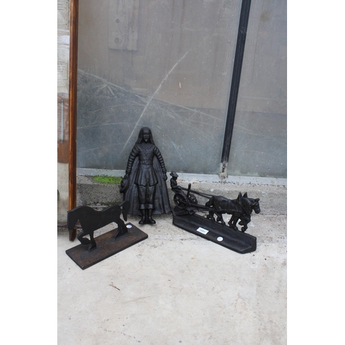 1517 - TWO CAST IRON HORSE DOOR STOPS AND A CAST IRON MALE FIGURE