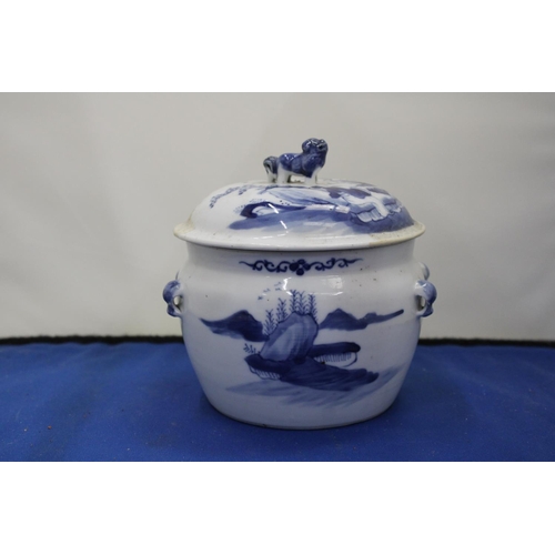 33 - AN ORIENTAL BLUE AND WHITE LIDDED POT WITH FOO DOG LID