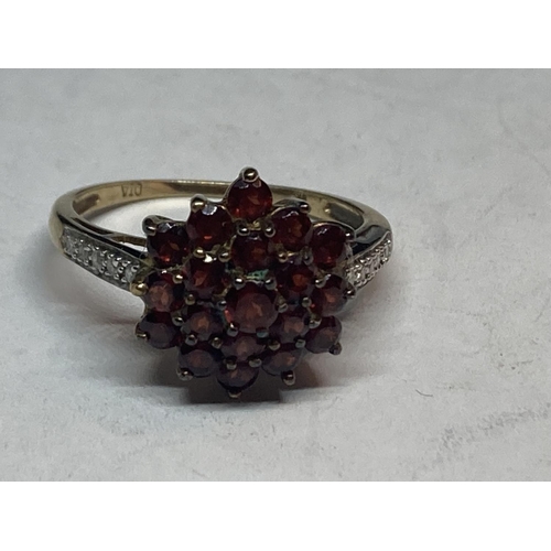 507 - A 9 CARAT GOLD CLUSTER RING WITH GARNETS AND DIAMONDS SIZE P