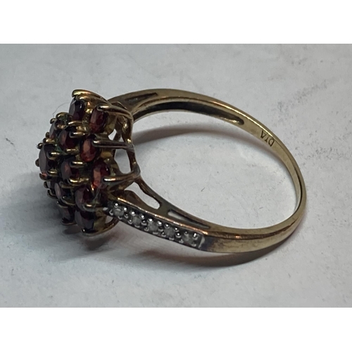 507 - A 9 CARAT GOLD CLUSTER RING WITH GARNETS AND DIAMONDS SIZE P