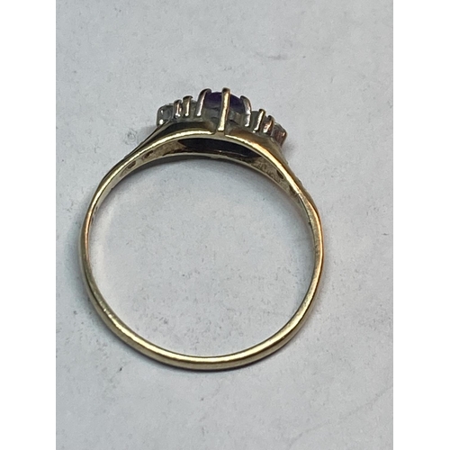 509 - A 9 CARAT GOLD RING WITH A CENTRE AMETHYST SURROUNDED BY CUBIC ZIRCONIAS SIZE Q/R