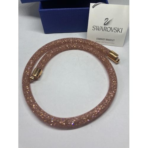 515 - A SWAROVSKI CRYSTAL PINK COLOURED STARDUST BRACELET IN ORIGINAL PRESENTATION BOX WITH TAG