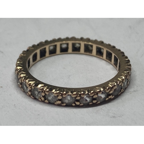 519 - A 9 CARAT GOLD BAND RING WITH CUBIC ZIRCONIAS ALL ROUND SIZE L/M