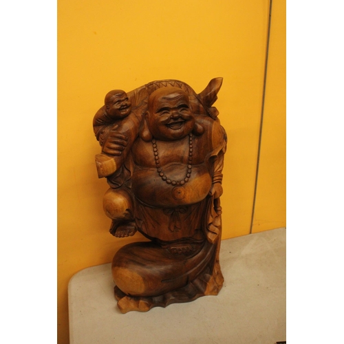 63 - A CARVED WOODEN LAUGHING BUDDAH FIGURE 20