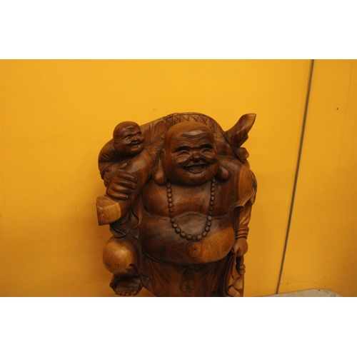 63 - A CARVED WOODEN LAUGHING BUDDAH FIGURE 20