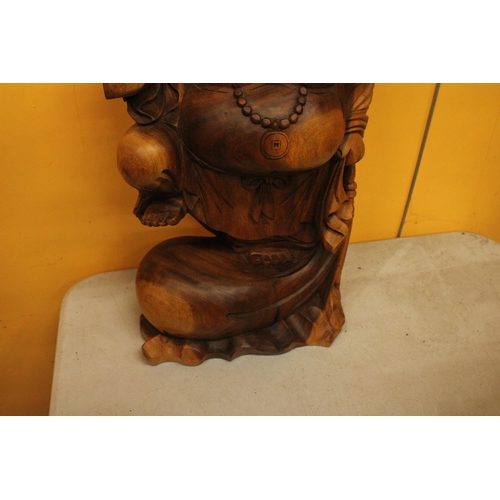 63 - A CARVED WOODEN LAUGHING BUDDAH FIGURE 20