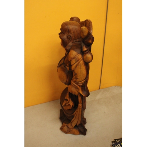 63 - A CARVED WOODEN LAUGHING BUDDAH FIGURE 20