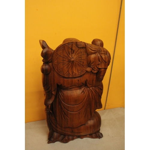 63 - A CARVED WOODEN LAUGHING BUDDAH FIGURE 20