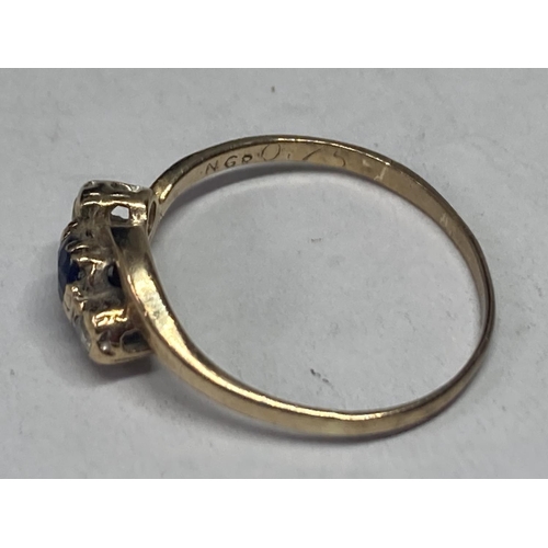 633 - A 9 CARAT GOLD RING WITH A CENTRE SAPPHIRE AND TWO DIAMONDS SIZE N/O