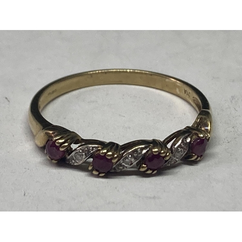 634 - A 9 CARAT GOLD RING WITH RUBIES AND DIAMONDS ON A TWIST DESIGN SIZE T