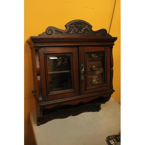 73 - A WALLMOUNTED CABINET WITH THREE INNER DRAWERS, SHELVES AND TWO GLASS DOORS AND KEY