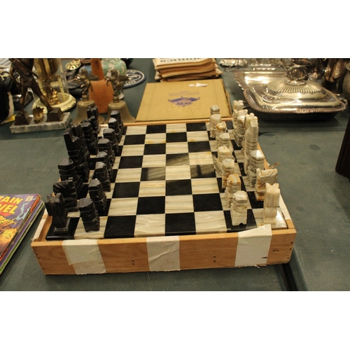 74 - A COMPLETE MARBLE AND STONE CHESS SET WITH CARVED PIECES