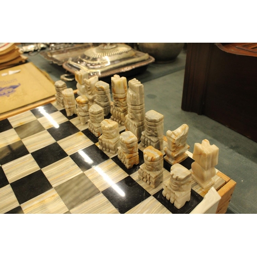 74 - A COMPLETE MARBLE AND STONE CHESS SET WITH CARVED PIECES