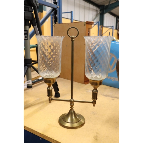 988 - A BRASS TWO-ARM STUDENT CANDLE LAMP WITH HURRICANE SHADES