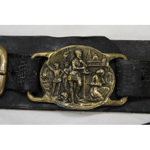 177 - TWO HORSE BRASSES ON LEATHER STRAPS