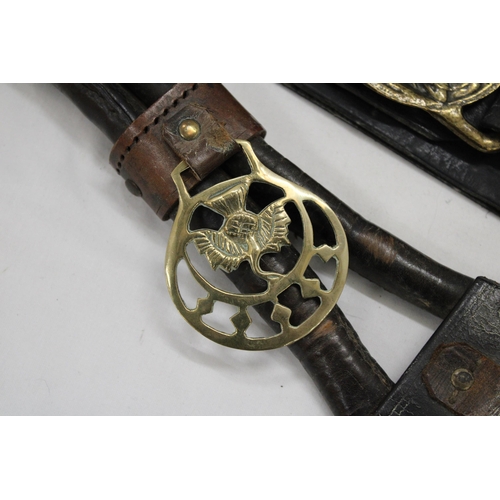 177 - TWO HORSE BRASSES ON LEATHER STRAPS