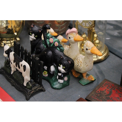 193 - THREE CAST IRON ITEMS TO INCLUDE A LETTER RACK WITH COW DECORATION, PLUS DUCK AND CAT DOOR STOPS