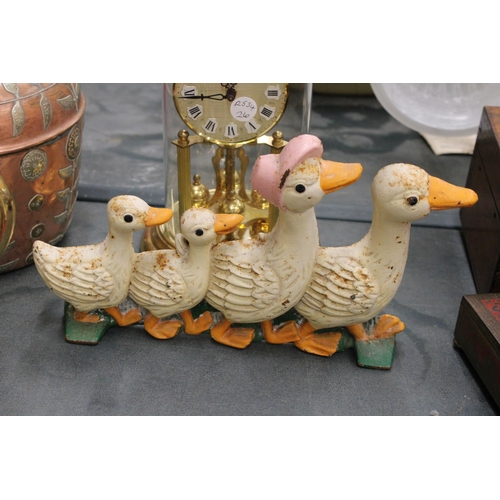 193 - THREE CAST IRON ITEMS TO INCLUDE A LETTER RACK WITH COW DECORATION, PLUS DUCK AND CAT DOOR STOPS