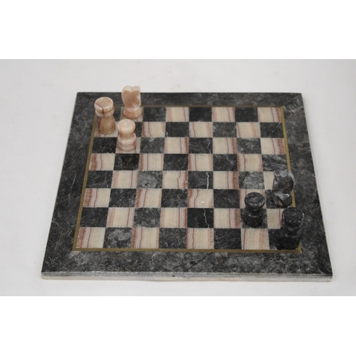 203 - A VINTAGE MARBLE CHESS BOARD AND CHESS PIECES - COMPLETE