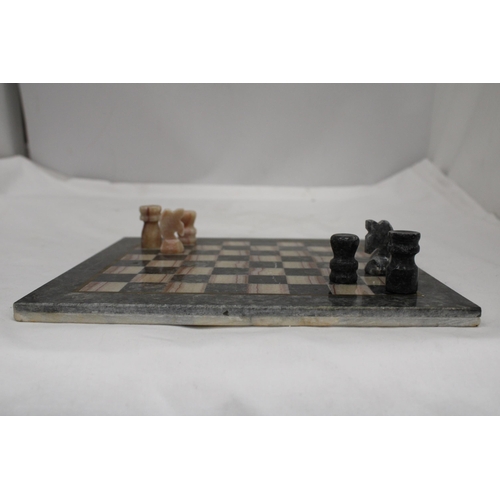 203 - A VINTAGE MARBLE CHESS BOARD AND CHESS PIECES - COMPLETE