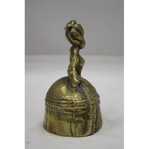 214 - A VINTAGE BRASS BELL MODELLED AS A VICTORIAN WOMAN