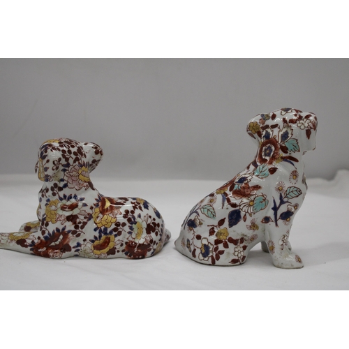 227 - A PAIR OF FLORAL DOGS, ONE WITH ORIENTAL MARKS TO THE BASE