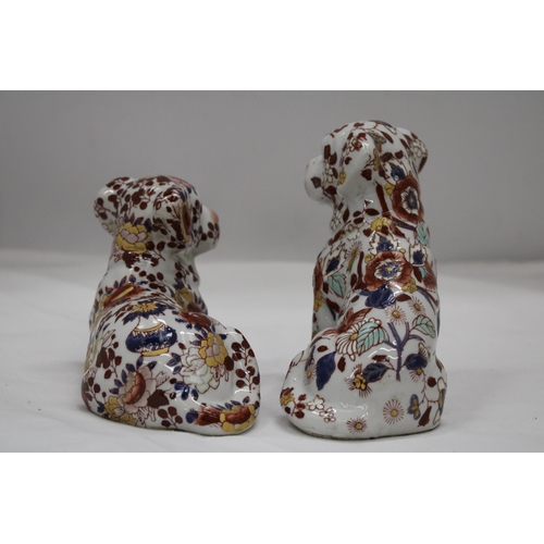 227 - A PAIR OF FLORAL DOGS, ONE WITH ORIENTAL MARKS TO THE BASE