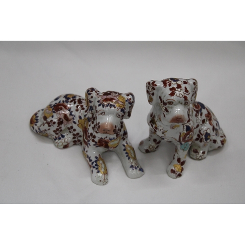 227 - A PAIR OF FLORAL DOGS, ONE WITH ORIENTAL MARKS TO THE BASE