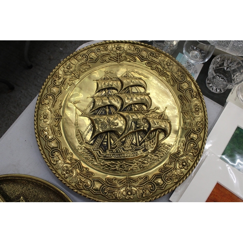 268 - TWO LARGE BRASS VINTAGE WALL PLAQUES WITH SHIP DECORATION, DIAMETER 36CM PLUS A RECTANGULAR WALL PLA... 