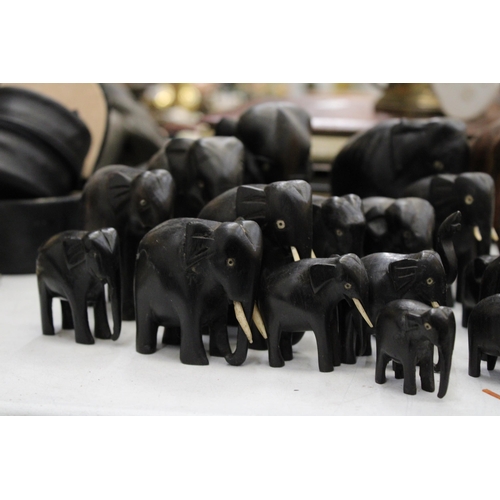 299 - A LARGE COLLECTION OF VARIOUS SIZES OF WOODEN ASIAN ELEPHANTS