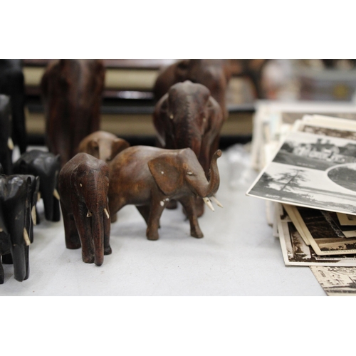 299 - A LARGE COLLECTION OF VARIOUS SIZES OF WOODEN ASIAN ELEPHANTS