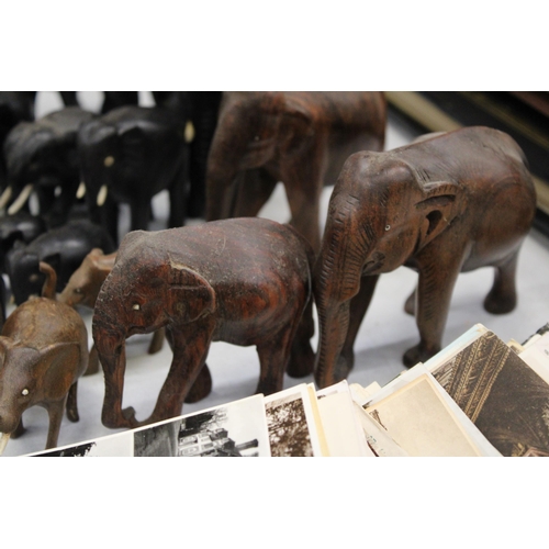 299 - A LARGE COLLECTION OF VARIOUS SIZES OF WOODEN ASIAN ELEPHANTS