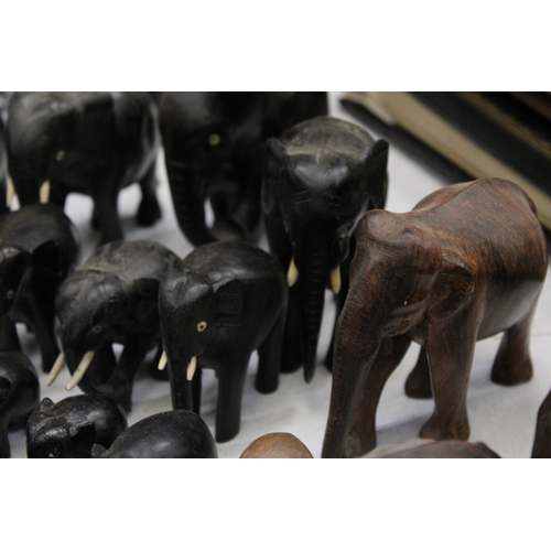 299 - A LARGE COLLECTION OF VARIOUS SIZES OF WOODEN ASIAN ELEPHANTS