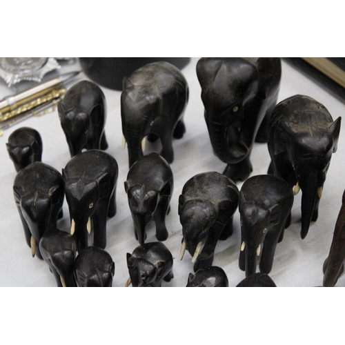 299 - A LARGE COLLECTION OF VARIOUS SIZES OF WOODEN ASIAN ELEPHANTS