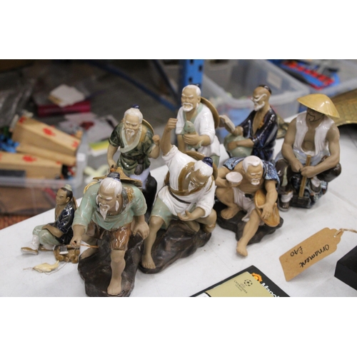 806 - EIGHT FIGURES OF ORIENTAL MUD MEN