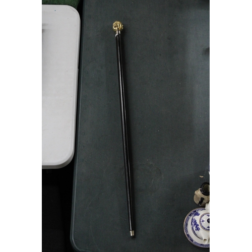 817 - A BRASS FOUR FACED BUDDHA HANDLE WALKING STICK