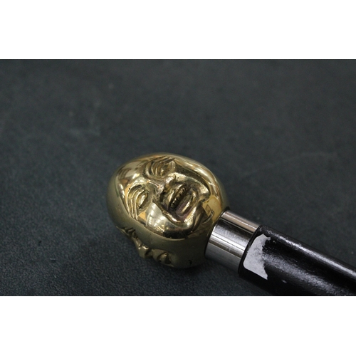 817 - A BRASS FOUR FACED BUDDHA HANDLE WALKING STICK