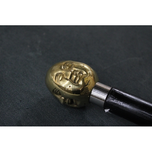 817 - A BRASS FOUR FACED BUDDHA HANDLE WALKING STICK