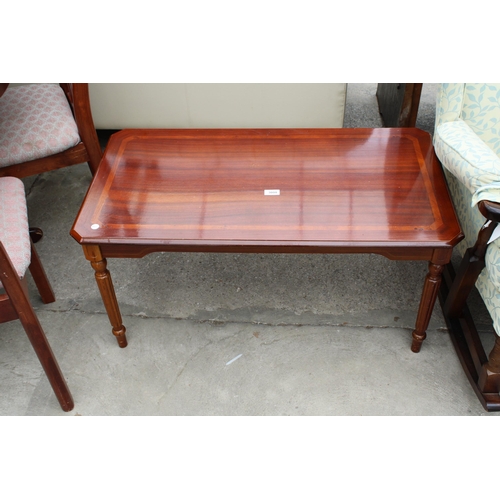 3000 - A MODERN POLISHED HARDWOOD COFFEE TABLE WITH CANTED CORNERS ON TURNED AND FLUTED LEGS, 37