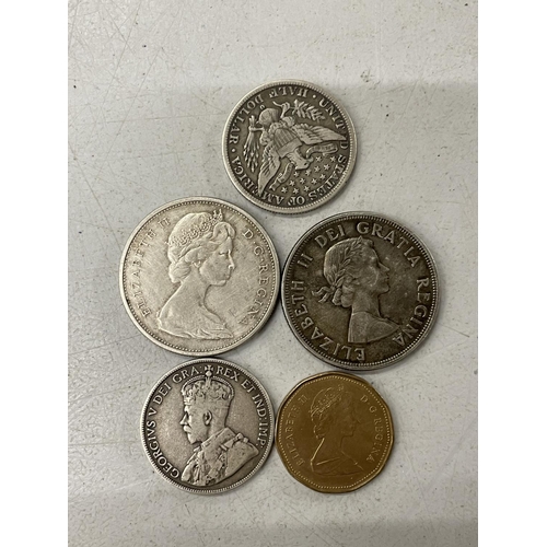 396A - AN 1894 US HALF DOLLAR AND FOUR CANADIAN COINS TO INCLUDE A 1964 AND A 1965 DOLLAR, A 1913 50 CENT A... 