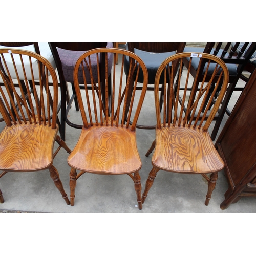 3024 - A SET OF EIGHT ELM R.W.F.CO WINDSOR STYLE DINING CHAIRS WITH STICK BACKS AND CRINOLINE BOWS