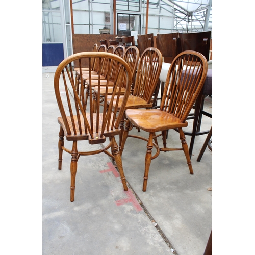 3024 - A SET OF EIGHT ELM R.W.F.CO WINDSOR STYLE DINING CHAIRS WITH STICK BACKS AND CRINOLINE BOWS