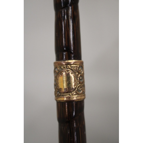 32 - A VINTAGE WALKING STICK WITH 9 CARAT GOLD FINIALS