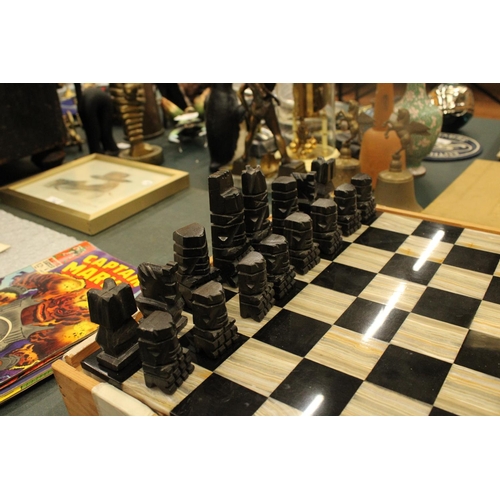 74 - A COMPLETE MARBLE AND STONE CHESS SET WITH CARVED PIECES