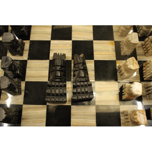 74 - A COMPLETE MARBLE AND STONE CHESS SET WITH CARVED PIECES