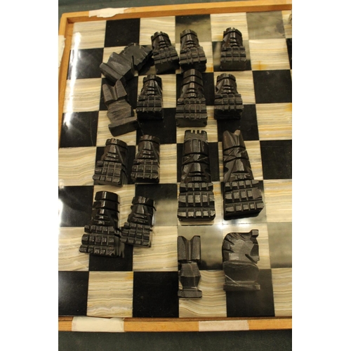 74 - A COMPLETE MARBLE AND STONE CHESS SET WITH CARVED PIECES