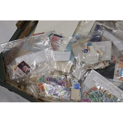 385 - A LARGE QUANTITY OF USED STAMPS ON ENVELOPES AND STAMPS TO INCLUDE SPAIN, CANADA, MALTA, ETC.,