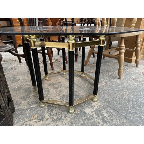 2899 - A RETRO OCTAGONAL SMOKED GLASS COFFEE TABLE ON BLACK AND BRASS EFFECT BASE